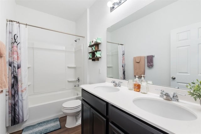 full bathroom with hardwood / wood-style floors, vanity, toilet, and shower / bath combo