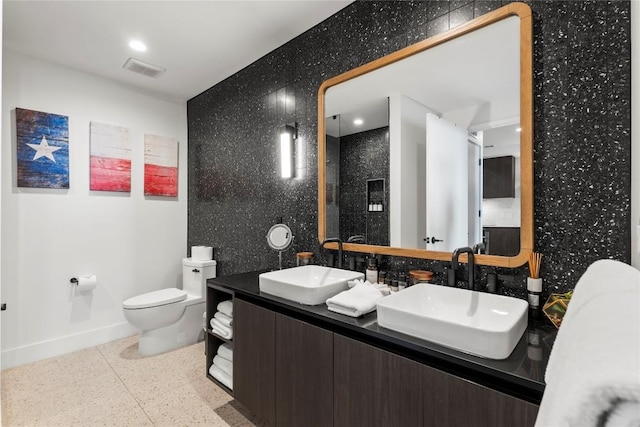 48 E Ave Unit 2506, Austin, TX 78701 - full bath with baseboards, toilet, double vanity, and a walk in shower