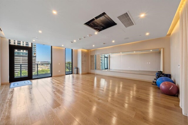 exercise room featuring light wood-type flooring