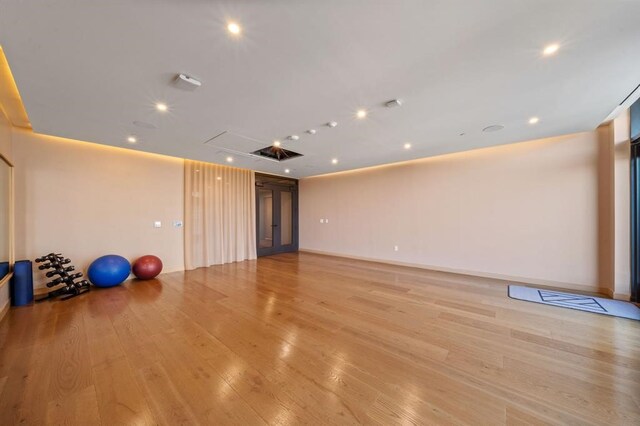 workout area with light hardwood / wood-style floors