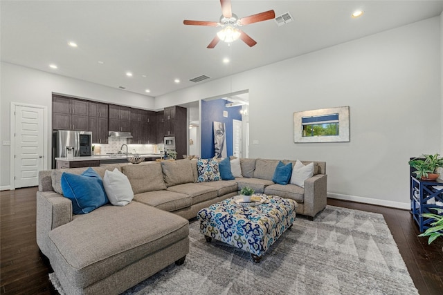 living room with ceiling fan, dark wood-type flooring, and sink