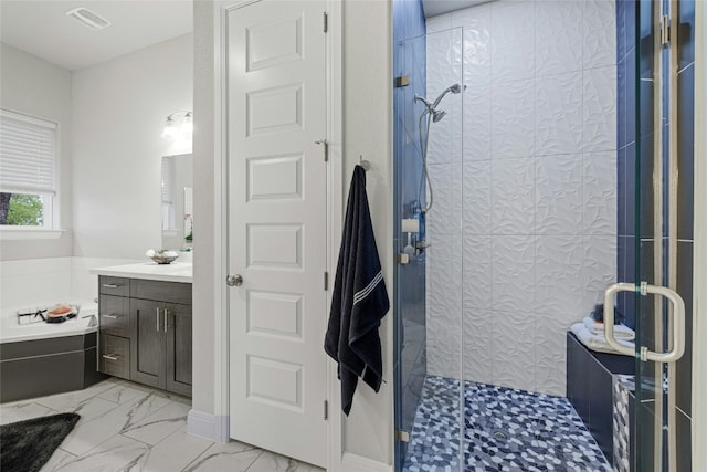 bathroom featuring vanity and an enclosed shower