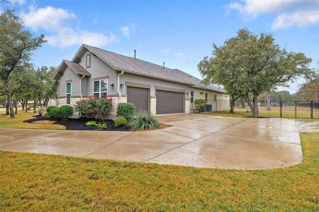 view of front of property with a front yard and a garage