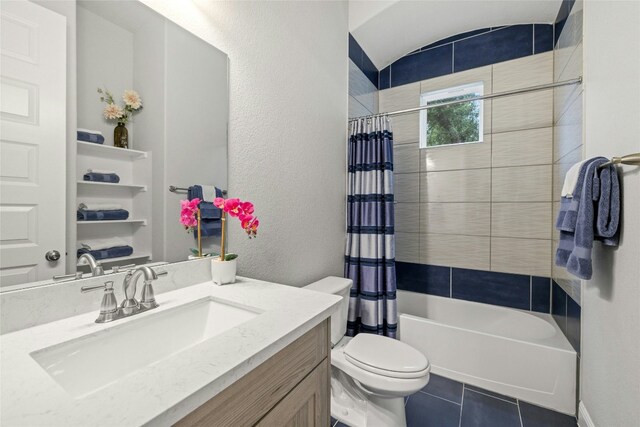 full bathroom with tile patterned floors, shower / bath combo, toilet, and vanity