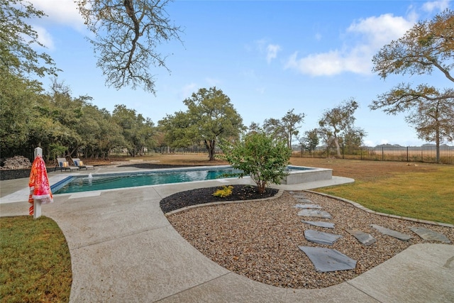 view of pool with a yard