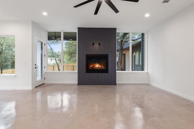 unfurnished living room with ceiling fan and a fireplace