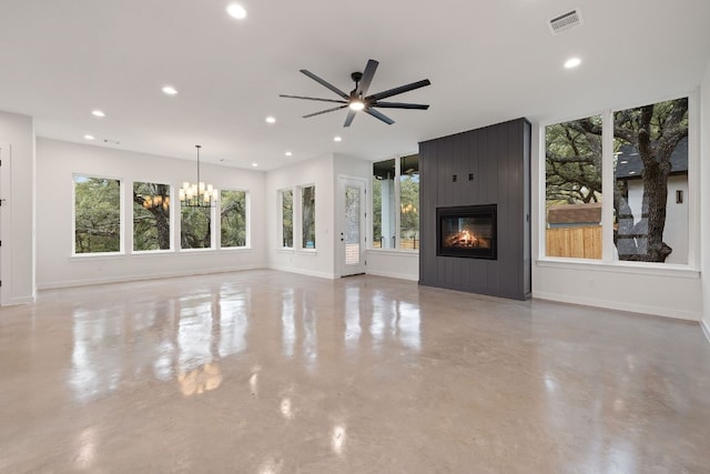 unfurnished living room with a fireplace and ceiling fan with notable chandelier