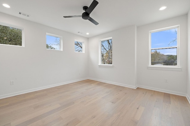 unfurnished room with light hardwood / wood-style floors, a wealth of natural light, and ceiling fan