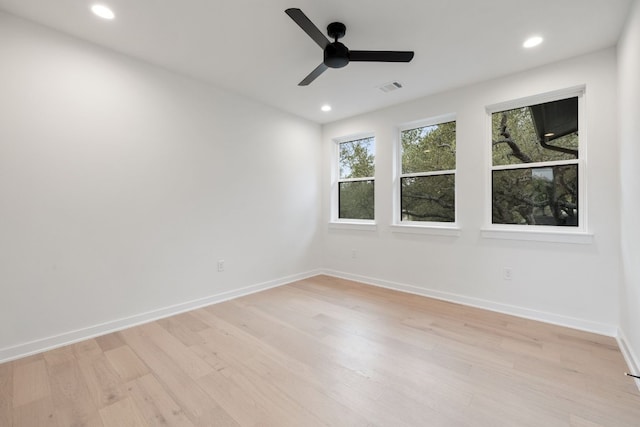 empty room featuring light hardwood / wood-style flooring and ceiling fan