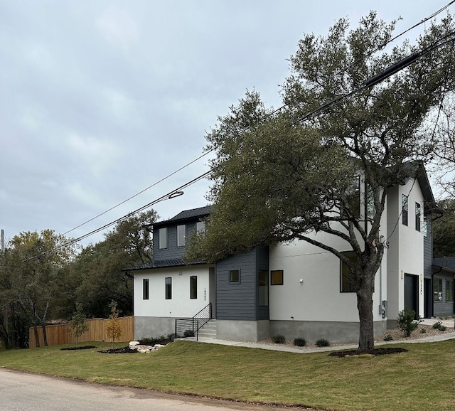 view of front of home with a garage and a front lawn