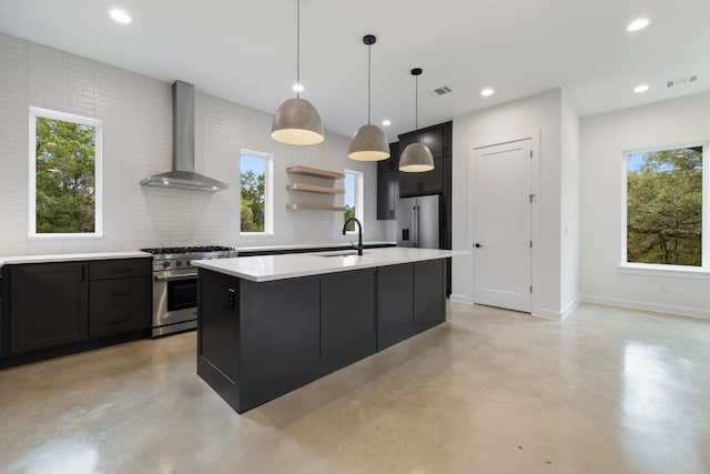 kitchen featuring high quality appliances, pendant lighting, wall chimney exhaust hood, and a healthy amount of sunlight