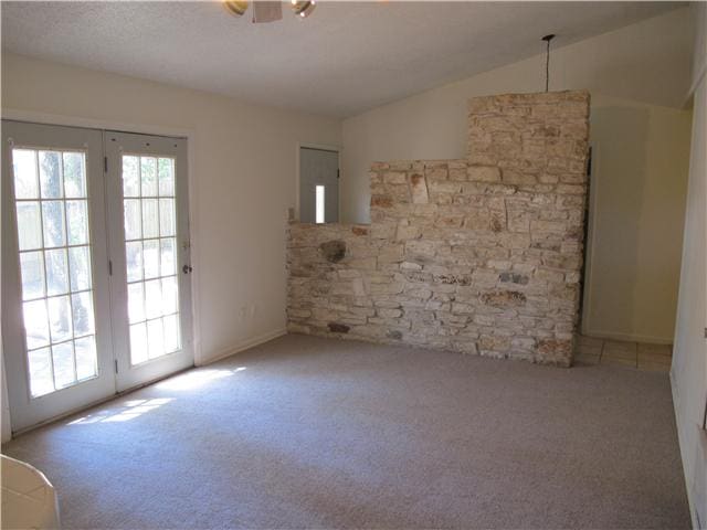 unfurnished room featuring ceiling fan, light colored carpet, and lofted ceiling