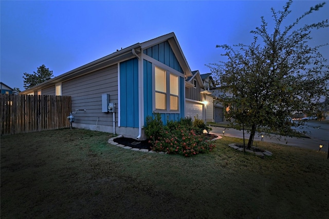 property exterior at dusk with a yard