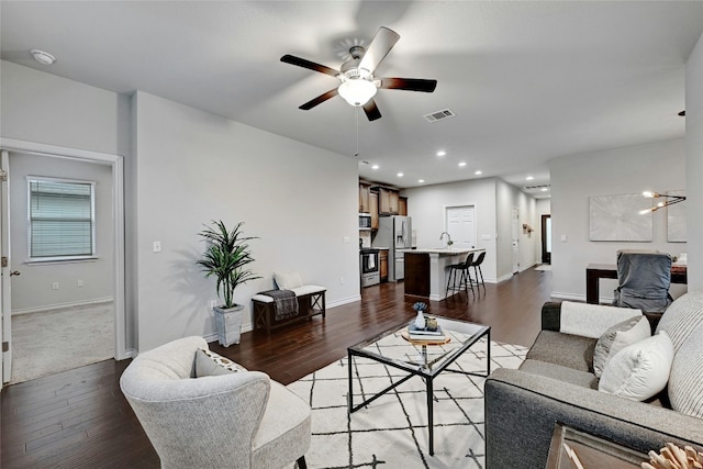 living room featuring light hardwood / wood-style flooring and ceiling fan