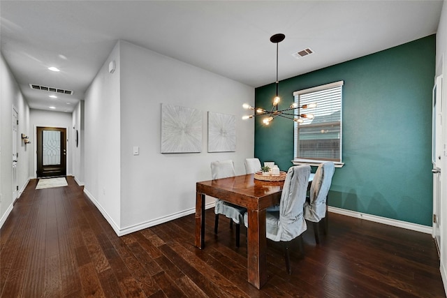 dining area featuring a chandelier and dark wood-type flooring