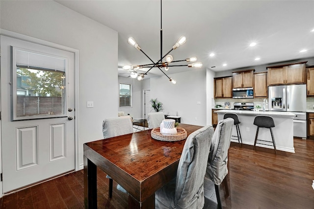 dining area with a chandelier and dark hardwood / wood-style floors