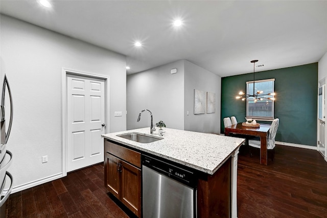 kitchen with dark wood-type flooring, sink, a center island with sink, dishwasher, and hanging light fixtures