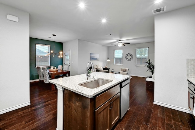 kitchen featuring hanging light fixtures, sink, stainless steel dishwasher, and dark hardwood / wood-style floors