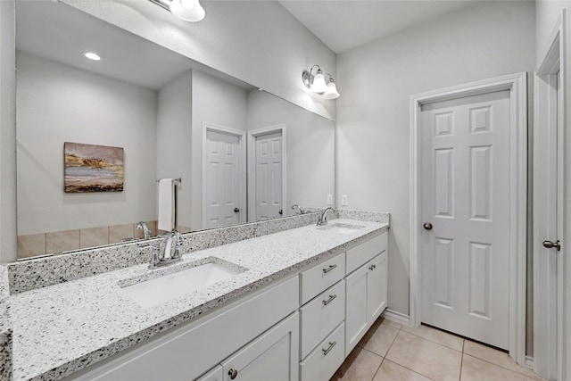 bathroom featuring tile patterned flooring and vanity