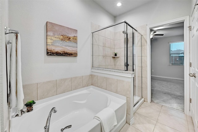 bathroom featuring tile patterned flooring and shower with separate bathtub