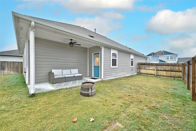 rear view of property with outdoor lounge area, a patio, ceiling fan, and a lawn