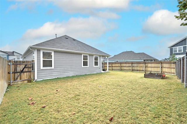 back of house with a lawn