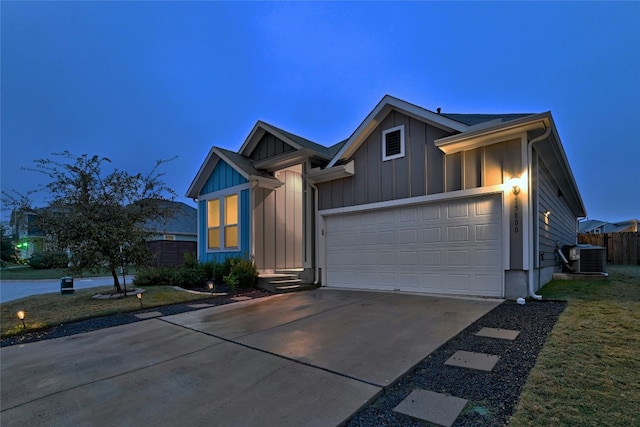 view of front of property with cooling unit and a garage