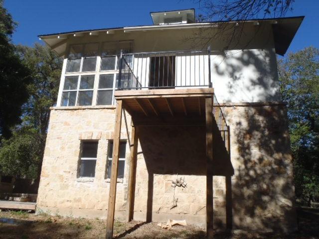 back of property with a balcony