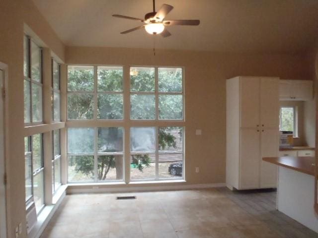 interior space featuring plenty of natural light and ceiling fan