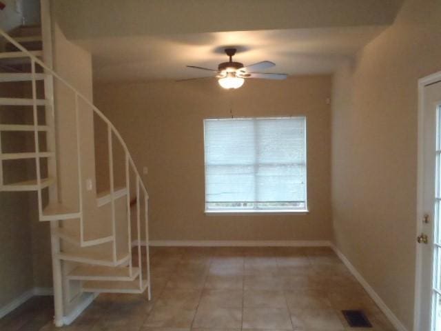 interior space featuring tile patterned floors and ceiling fan