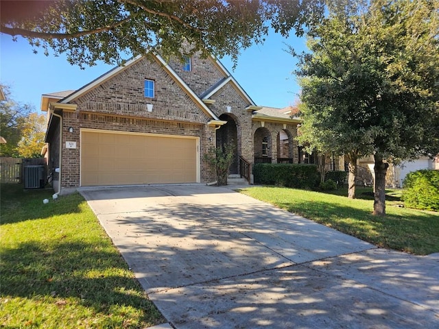 view of front of property featuring a front yard, a garage, and central air condition unit