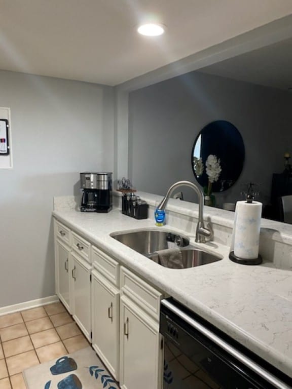 kitchen featuring dishwasher, white cabinetry, light tile patterned flooring, and sink