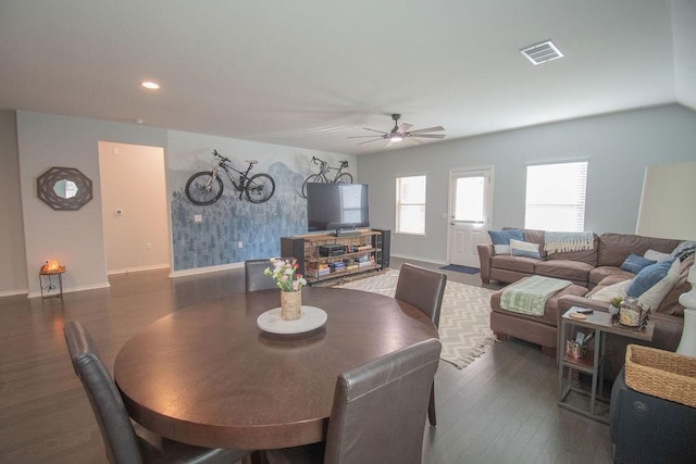 dining space with dark hardwood / wood-style floors and ceiling fan