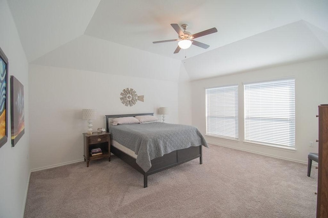 carpeted bedroom with ceiling fan and lofted ceiling