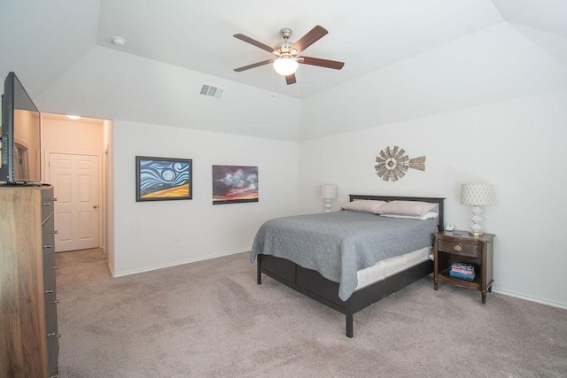 bedroom featuring light colored carpet, vaulted ceiling, and ceiling fan