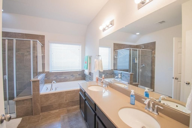 bathroom with tile patterned floors, separate shower and tub, and vaulted ceiling