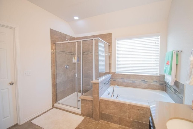 bathroom with tile patterned floors, lofted ceiling, sink, and plus walk in shower