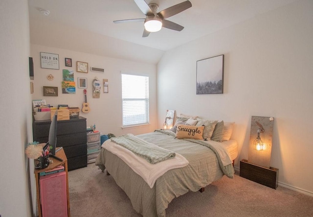 carpeted bedroom with vaulted ceiling and ceiling fan