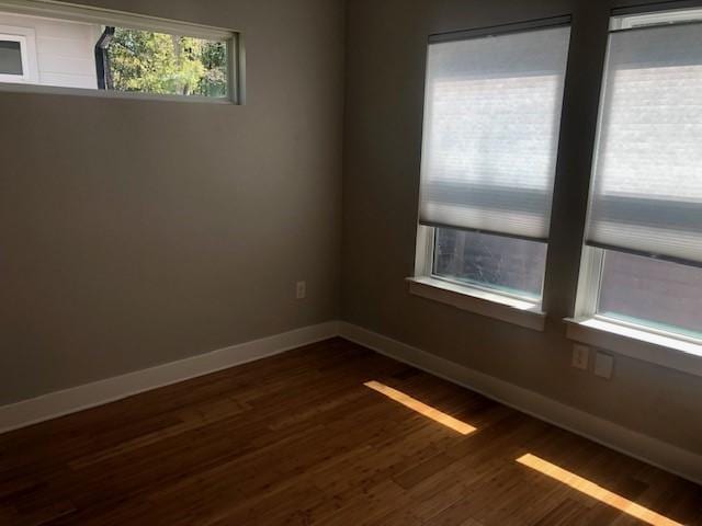 empty room featuring dark wood-type flooring