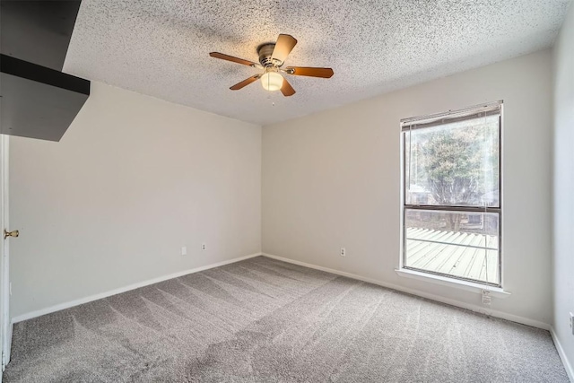 carpeted spare room with ceiling fan and a textured ceiling