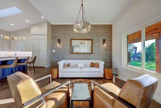 living room featuring lofted ceiling with skylight, dark wood-type flooring, and ornamental molding