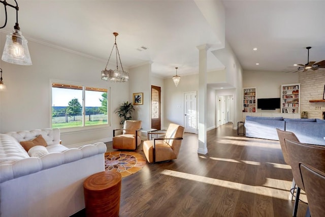 living room with ceiling fan with notable chandelier, dark hardwood / wood-style flooring, and ornamental molding