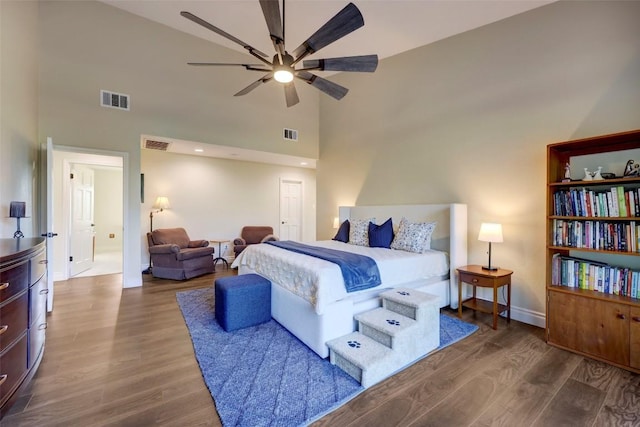 bedroom featuring ceiling fan, dark wood-type flooring, and high vaulted ceiling