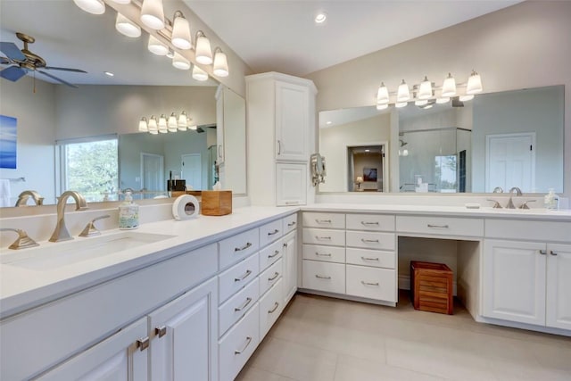 bathroom with ceiling fan, walk in shower, tile patterned floors, vaulted ceiling, and vanity