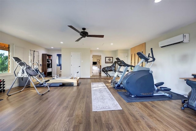 exercise area with hardwood / wood-style flooring, ceiling fan, and a wall mounted AC