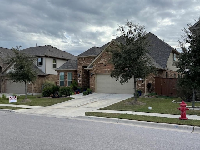 view of front of house featuring a garage and a front lawn