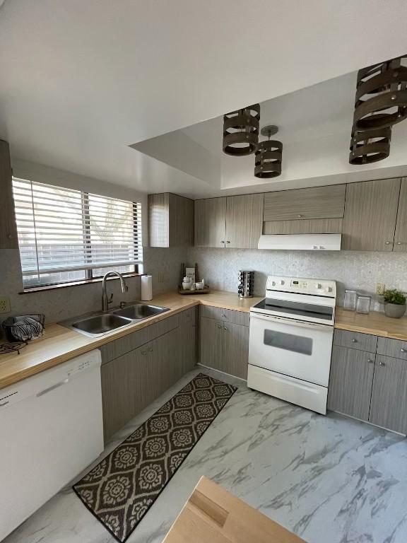 kitchen featuring white appliances and sink