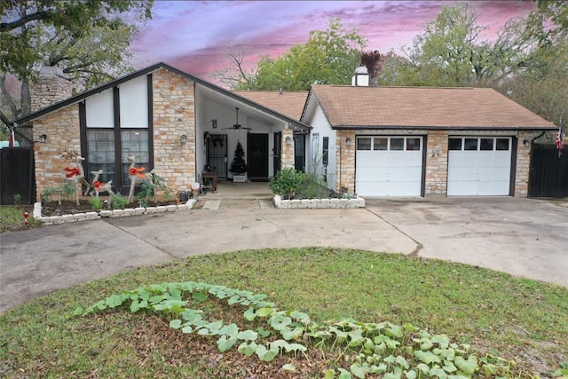 ranch-style home with covered porch, a garage, and ceiling fan