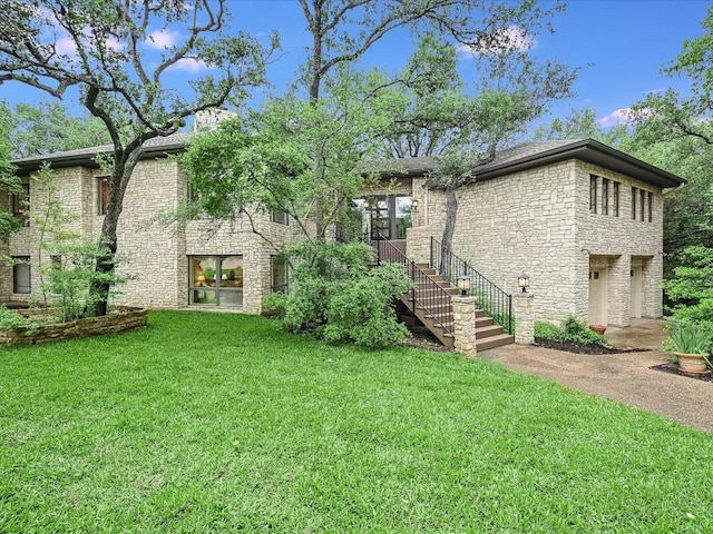3901 Prentice Ln, Austin, TX 78746 - back of property featuring stone siding, a lawn, and stairs