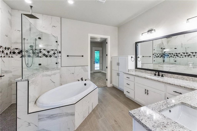 bathroom featuring vanity and plus walk in shower